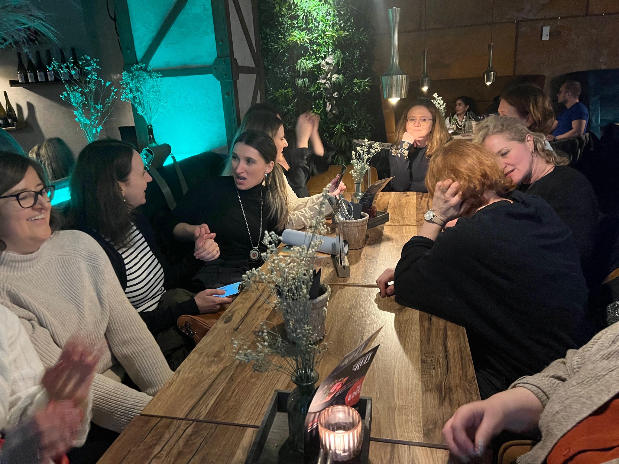 Women in conversation around a restaurant table