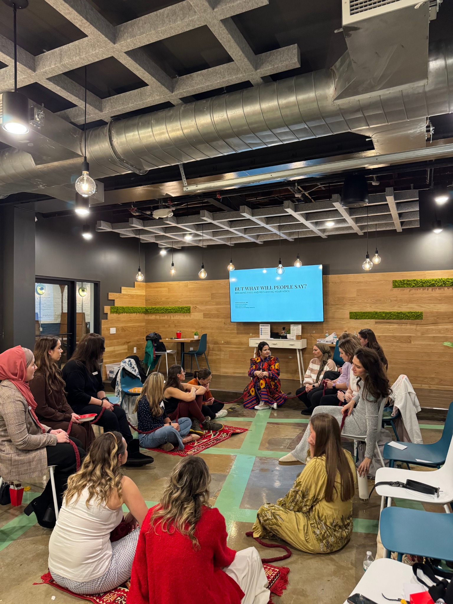 Selma seated with women in a facilitated conversation circle